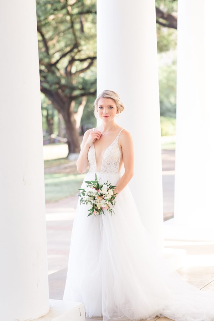 bride in gown with bouquet of pale pink and white flowers photographed by Courtney Bosworth Photography