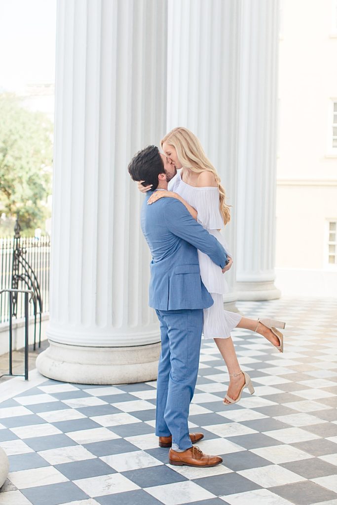 groom lifts bride during Charleston SC portraits