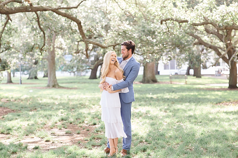 engaged couple laughs and smiles during Charleston engagement session