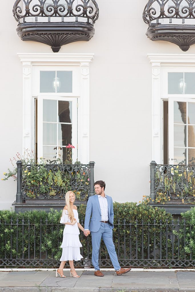 bride and groom walk along street in Charleston