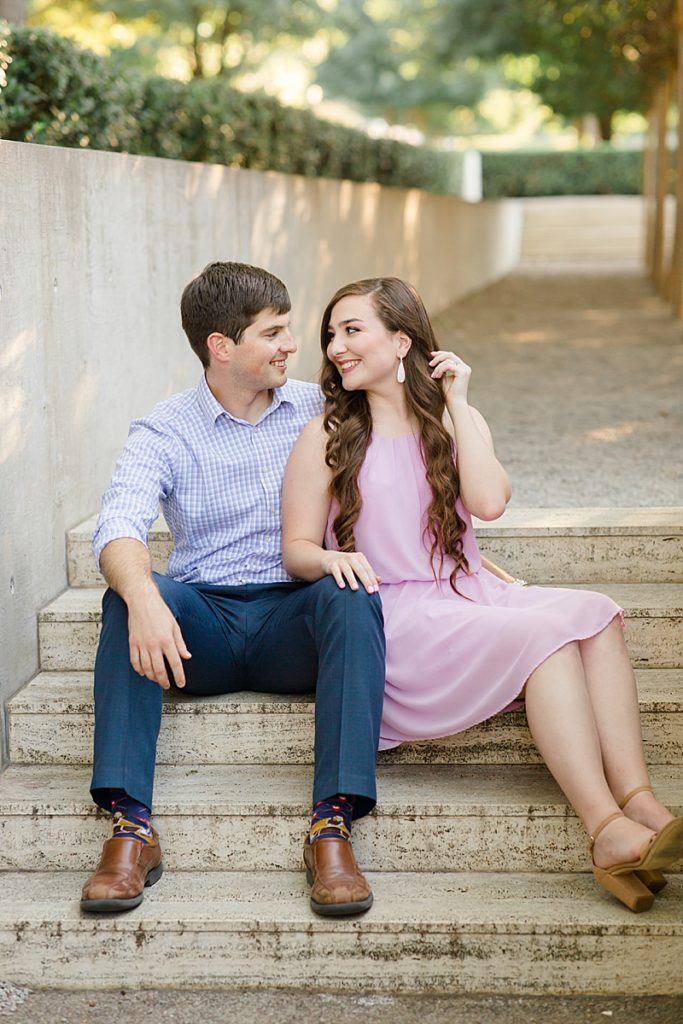 engaged couple sits on steps at Kimball Art Museum with Courtney Bosworth Photography