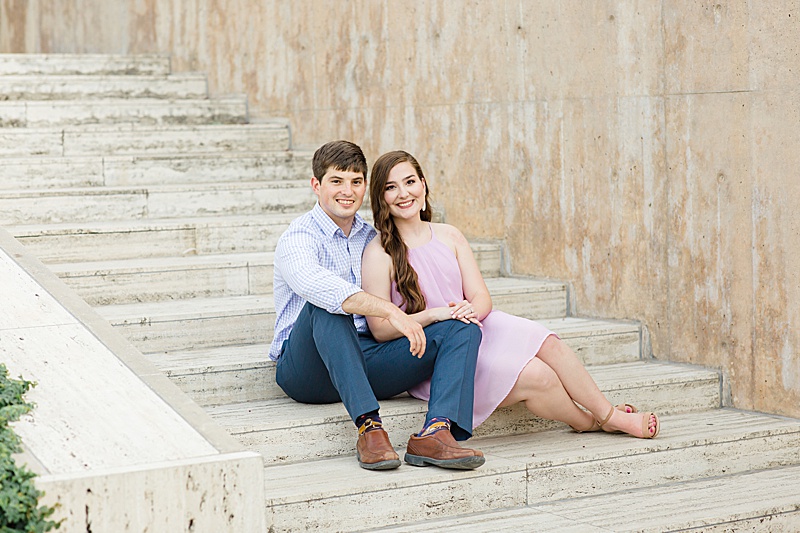couple sits on steps at Kimball Art Museum 