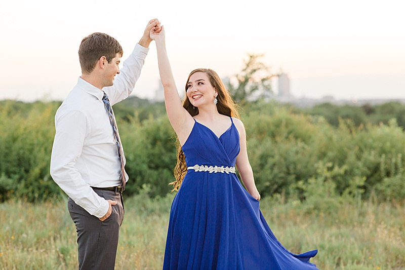 groom twirls bride-to-be during engagement portraits with Courtney Bosworth Photography