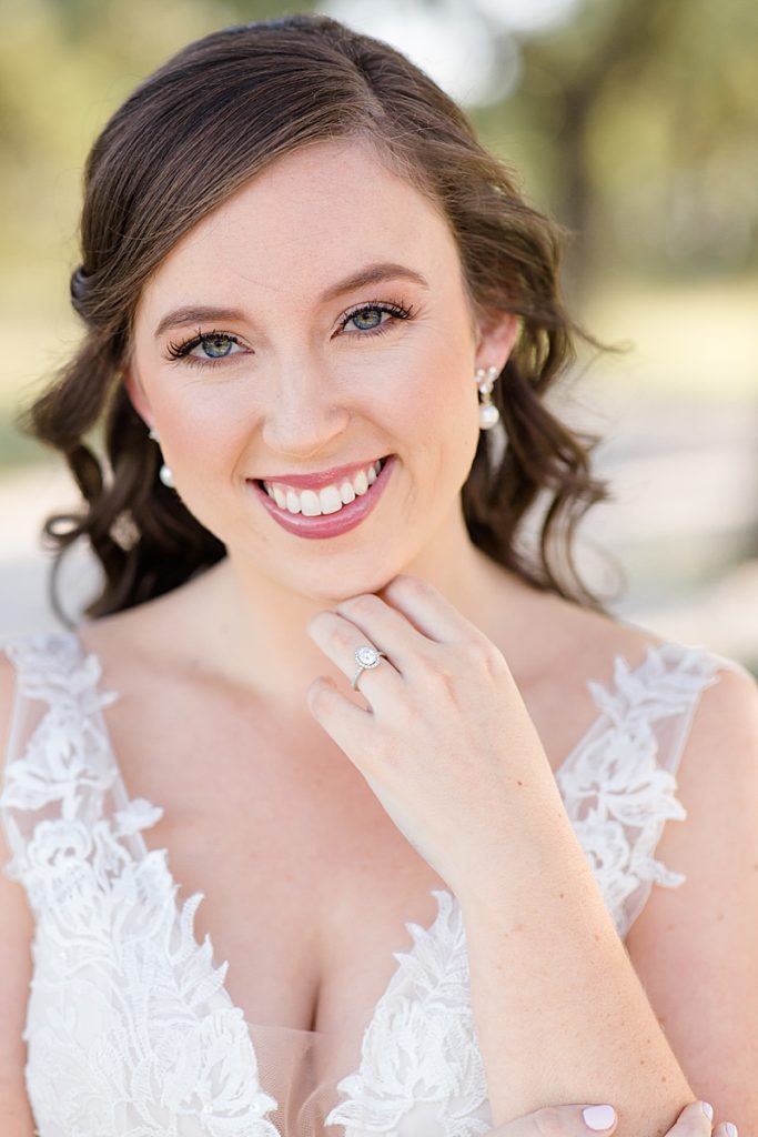 bride shows off wedding ring during bridal portraits with Courtney Bosworth Photography