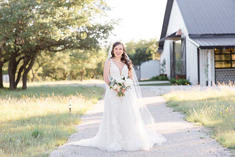 Courtney Bosworth Photography photographs bride with veil behind her at Mae's Ridge