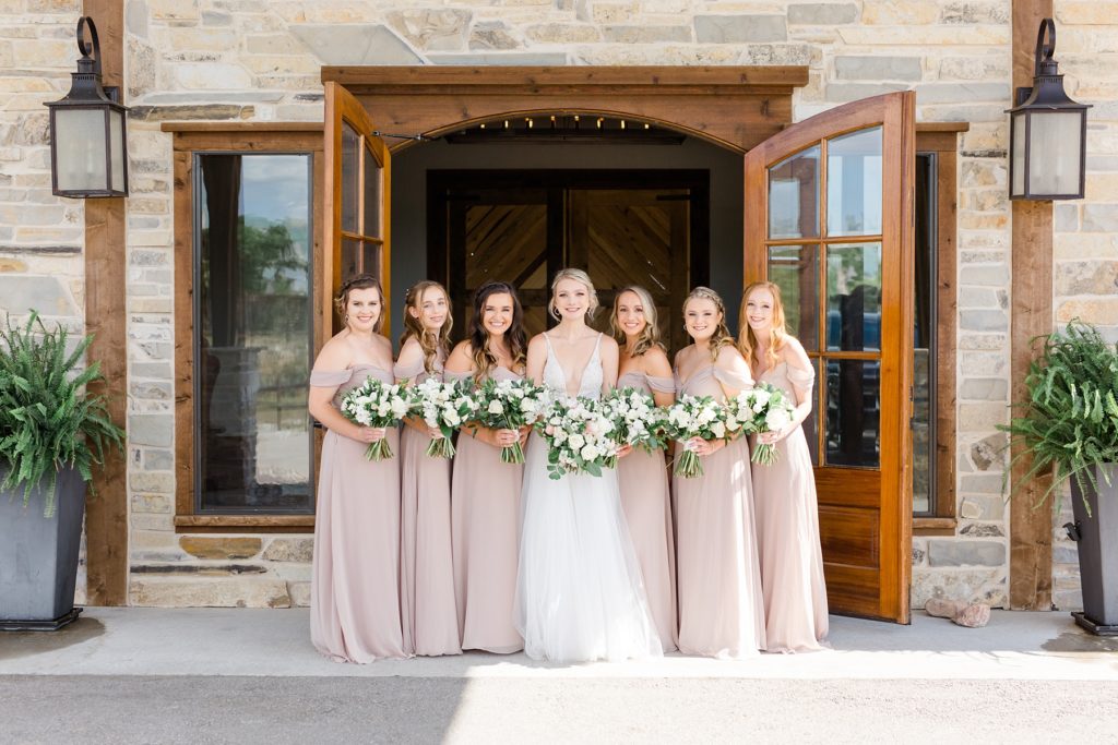 bride with bridesmaids in pink gowns outside Stone Crest Venue