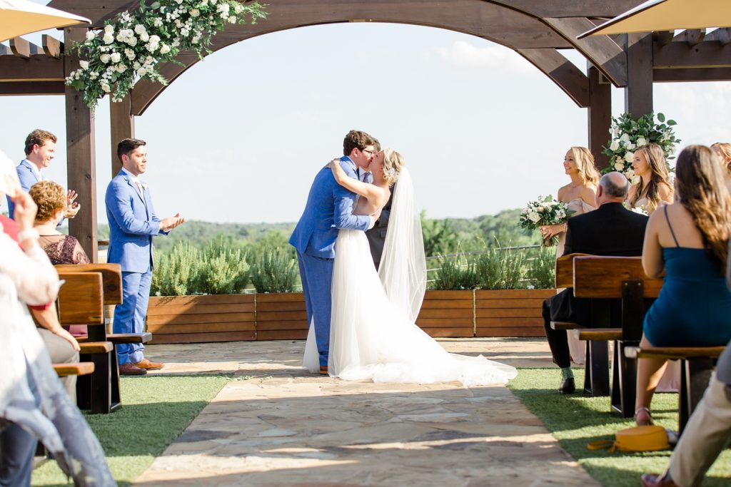 bride and groom kiss during wedding ceremony in Texas photographed by Courtney Bosworth Photography