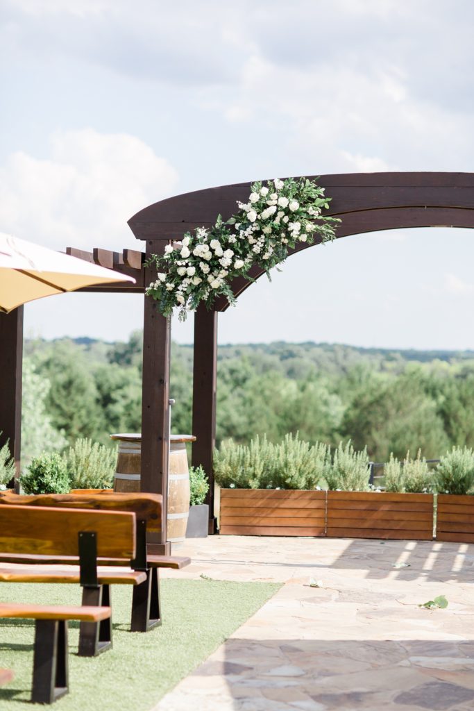 brown wooden arch with white flowers for Stone Crest Venue ceremony
