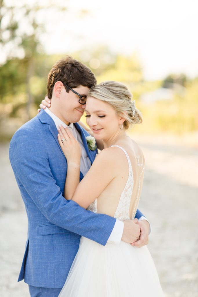 bride and groom embrace during Texas wedding portraits