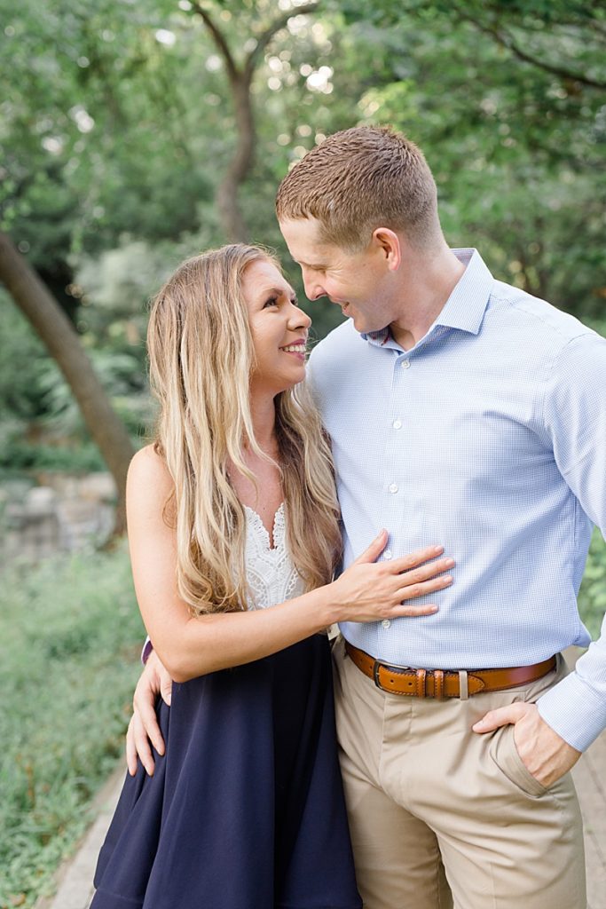 groom and bride look at each other during Texas engagement portraits