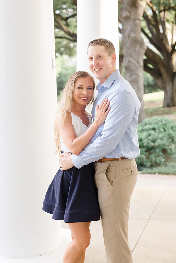 bride and groom pose by Texas historical home