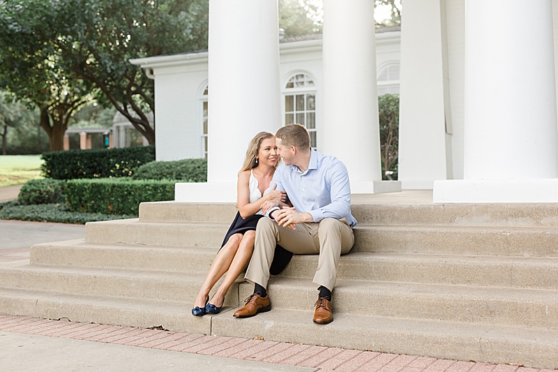 couple poses on steps of Arlington Hall at Lee Park