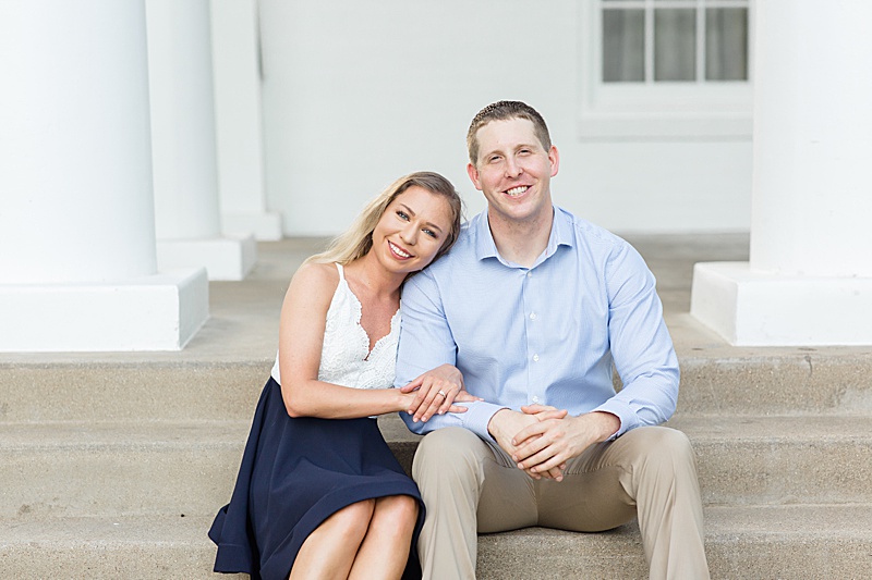 engaged couple sits together on steps in Dallas TX