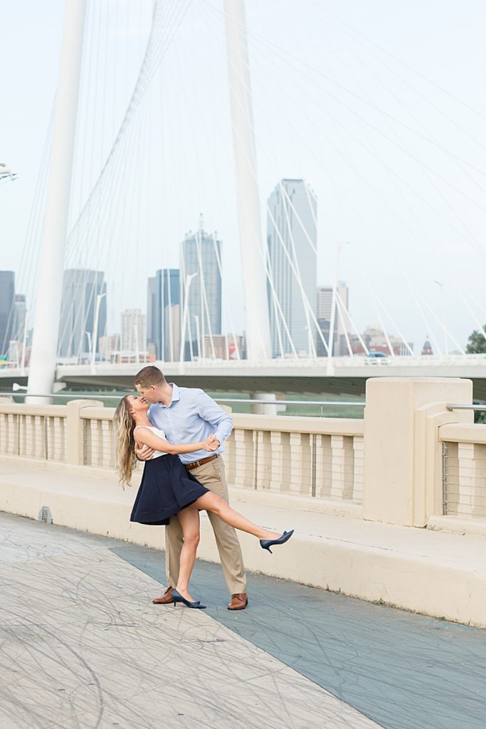 engaged couple kisses on Margaret Hunt Hill Bridge