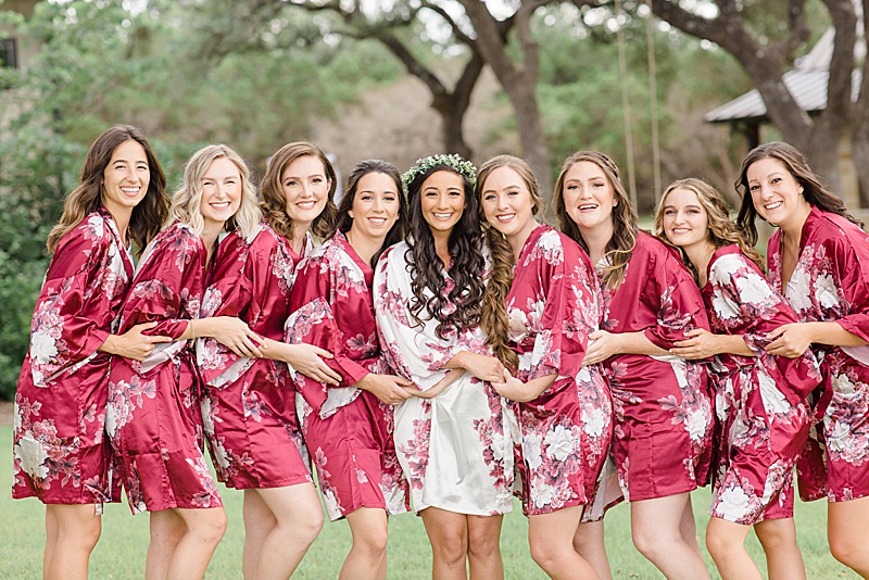 bride and bridesmaids pose in red robes