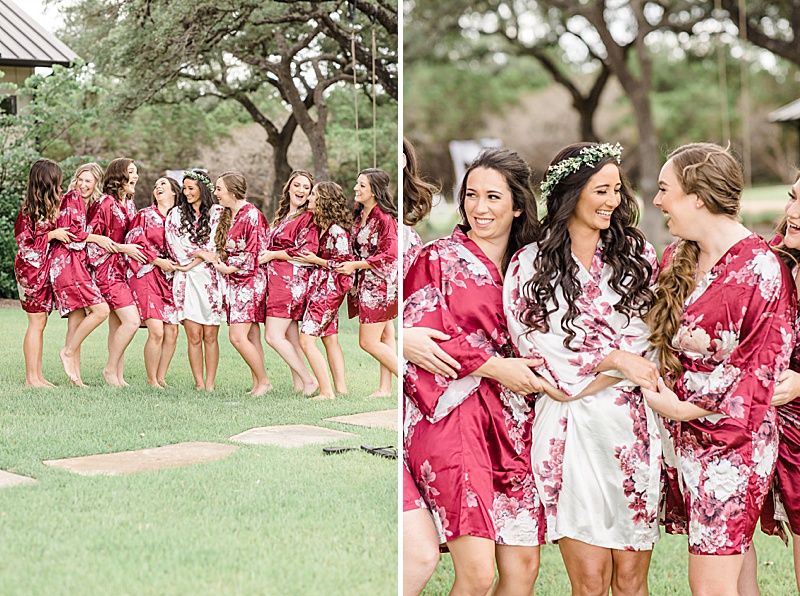bridesmaids smile with bride in matching red robes