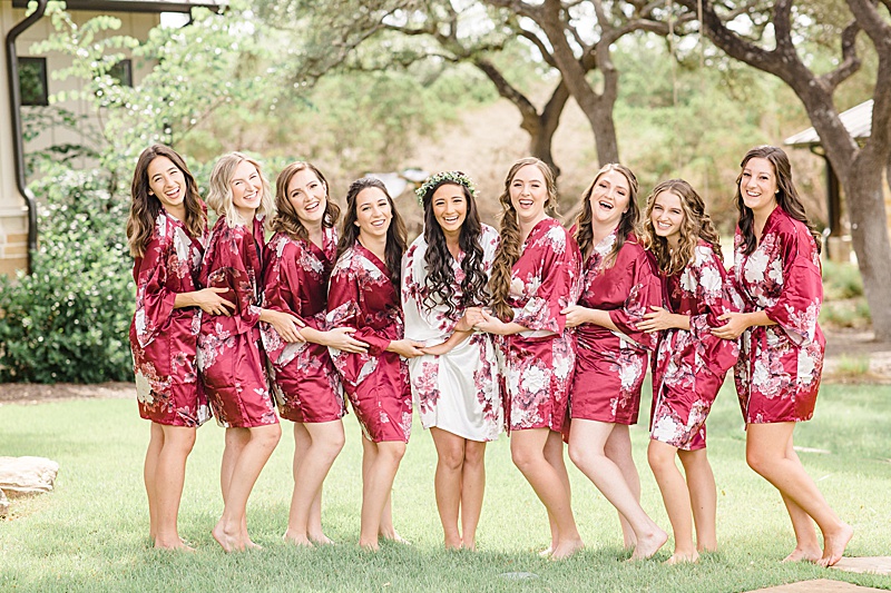 bridesmaids prepare in red floral robes