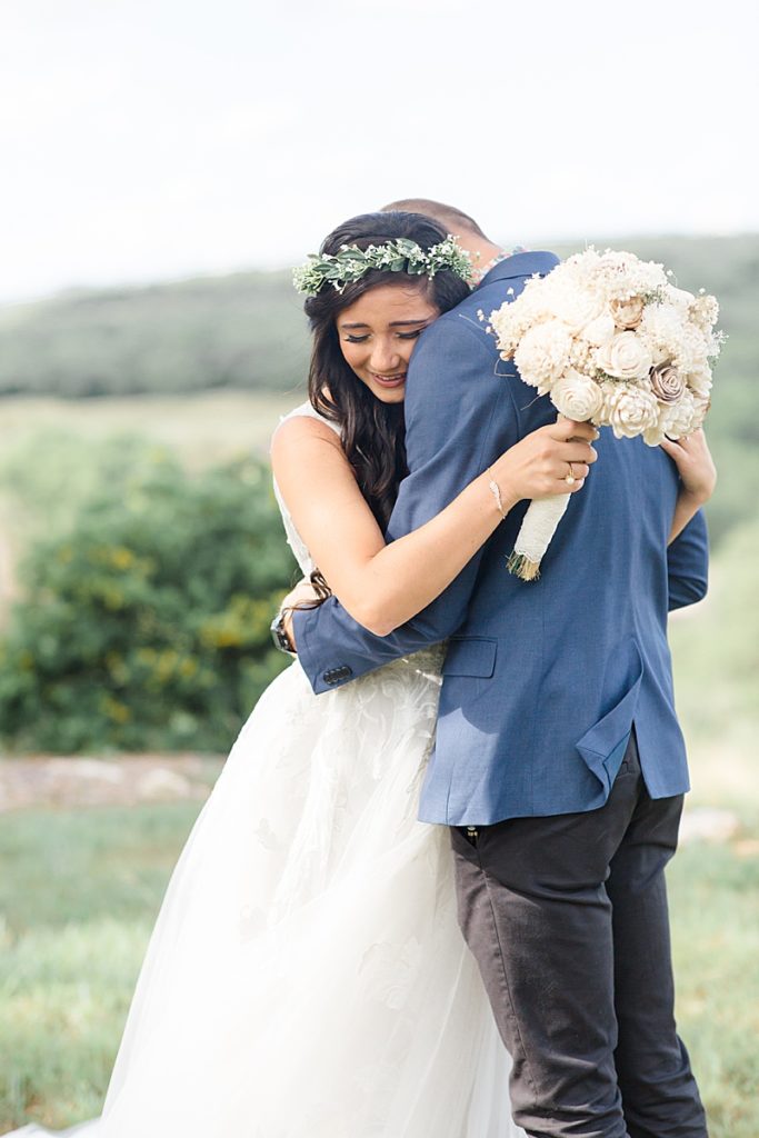 bride cries while hugging brother during summer wedding