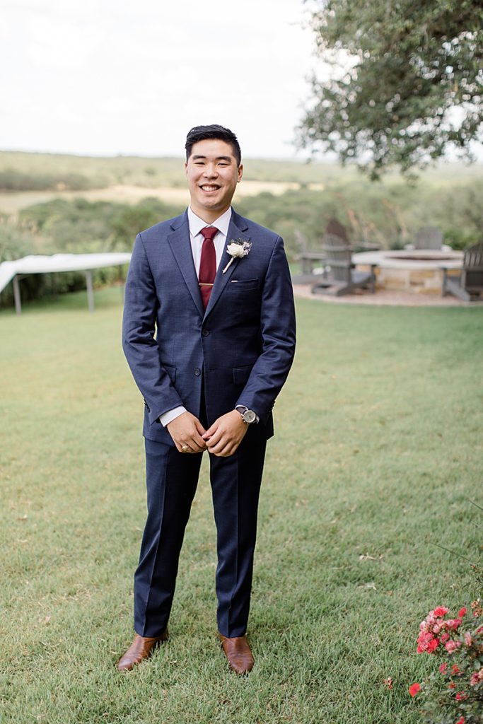 navy suit with red tie for groom