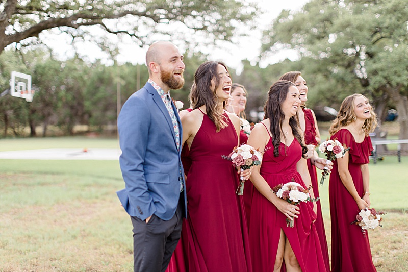 bridesmaids and brother of the bride smile during bride's reveal