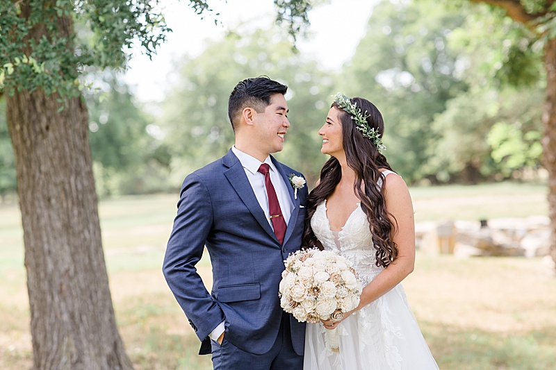 bride and groom smile during portraits on Austin Texas wedding day