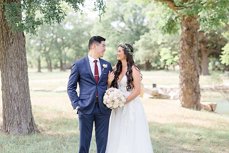 bride and groom smile at each other during portraits in Austin TX
