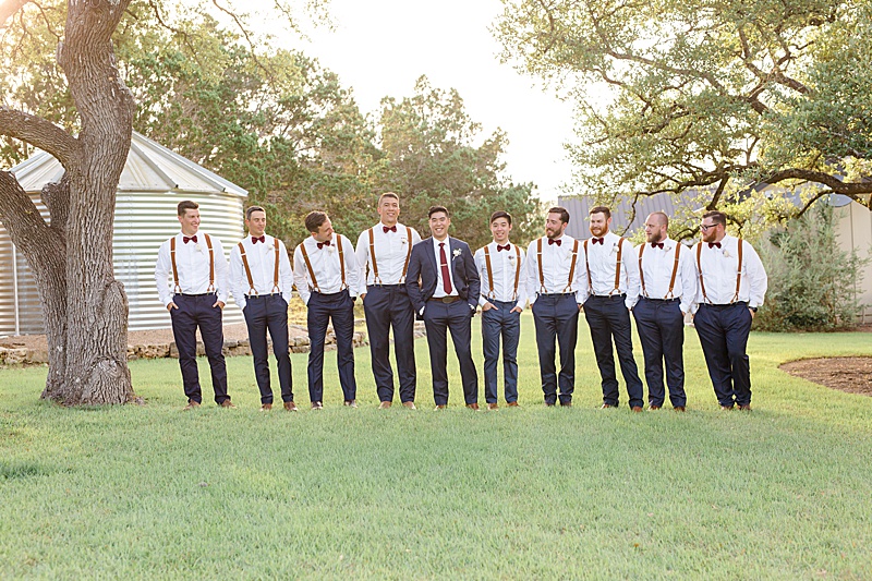 groomsmen walk on Austin Texas ranch