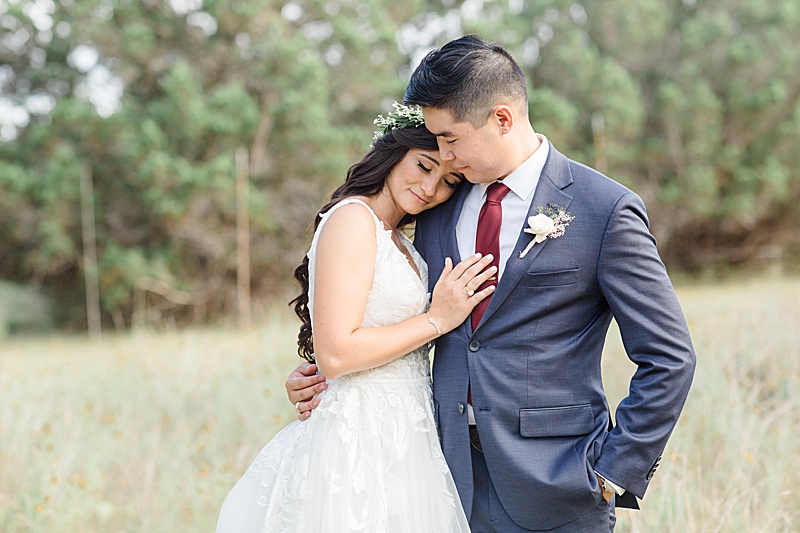 bride snuggles with groom during Austin Texas wedding photos