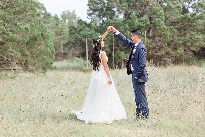 groom twirls bride during sunset wedding portraits in Austin TX