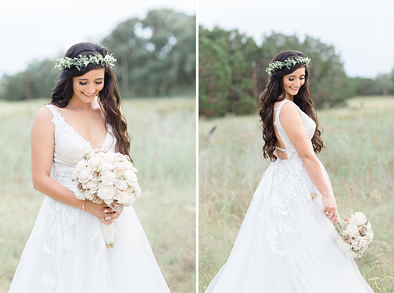 bride looks down at bouquet in field on ranch in Texas