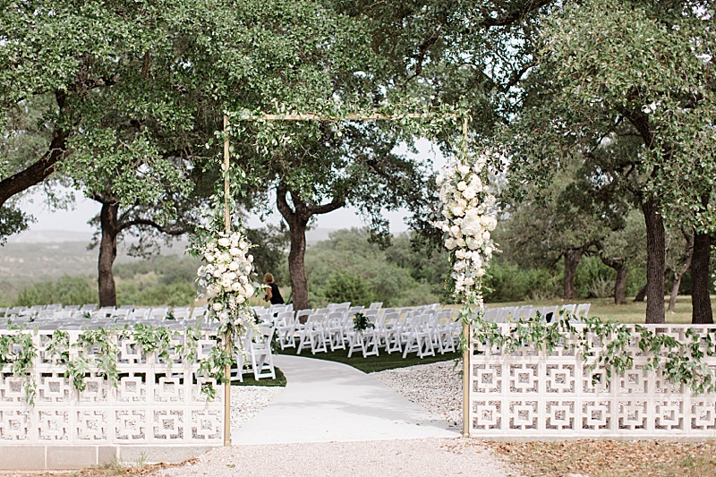 arbor with ivory flowers and greenery