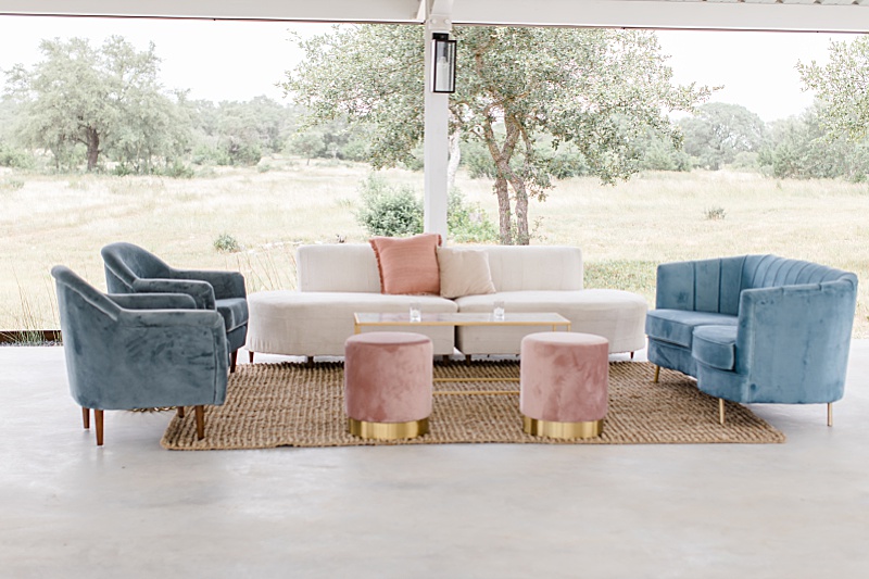 seating area with pink stools and white couches