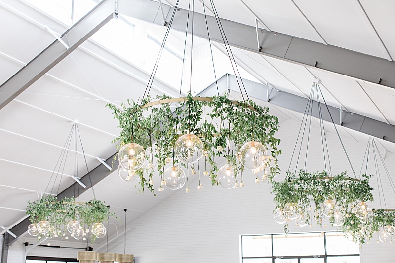 hanging floral display with modern light fixtures