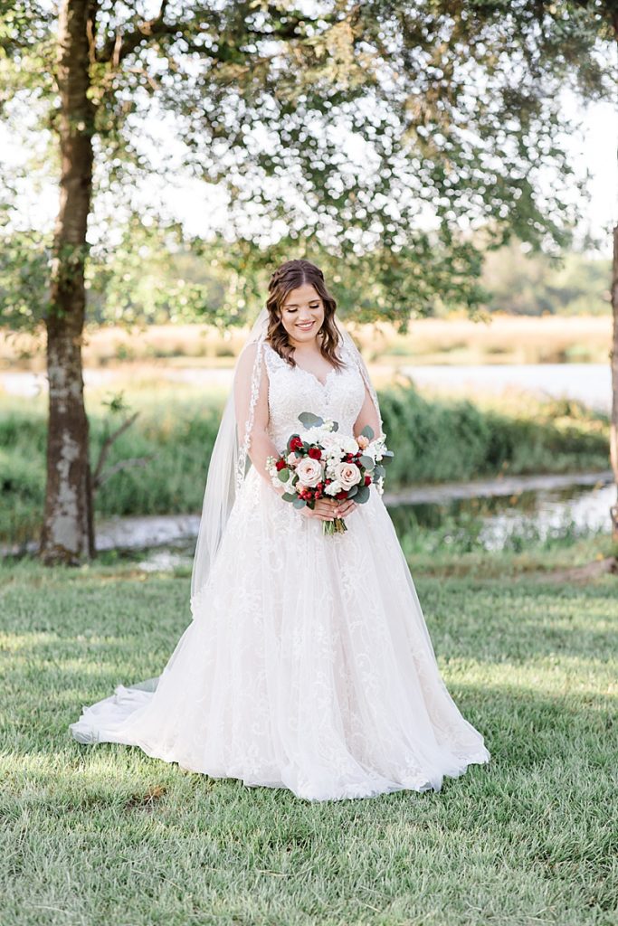 Texas bride poses with bouquet in wedding dress