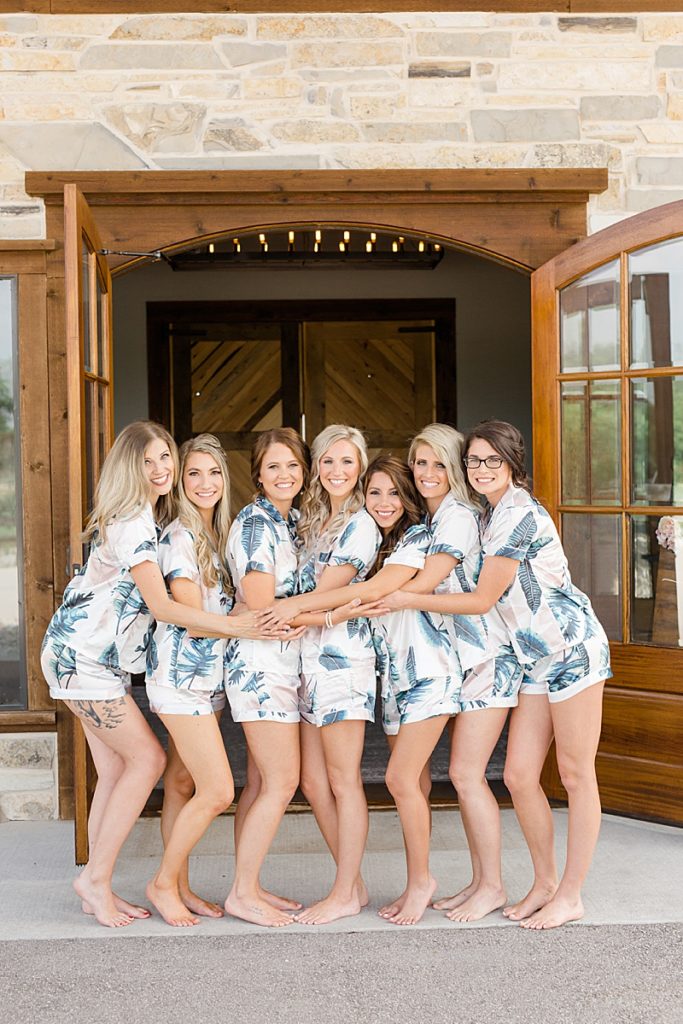 bridesmaids in matching pajamas prep for Stone Crest Venue wedding