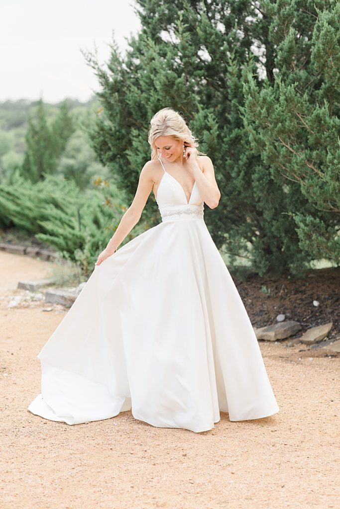 bride twirls wedding gown after first look