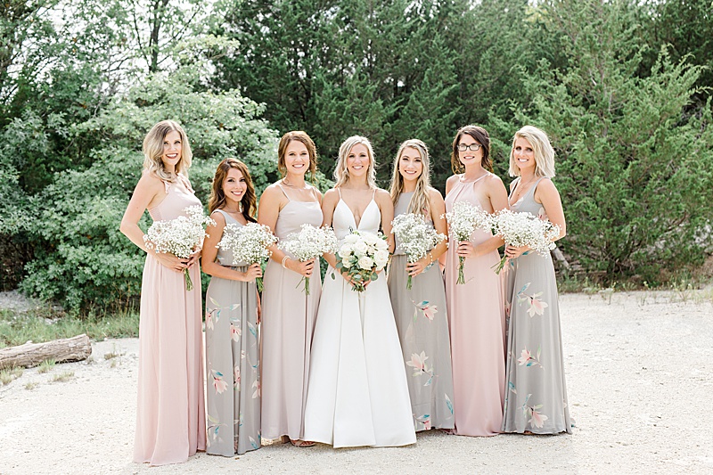 bride and bridesmaids in mismatched gowns pose at Stone Crest Venue