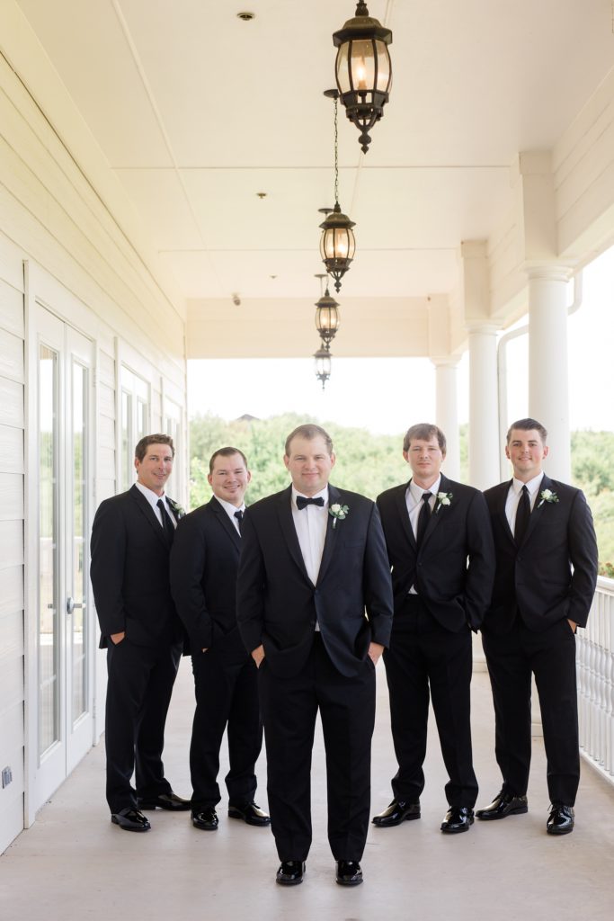 groom and four groomsmen pose at The Milestone Denton