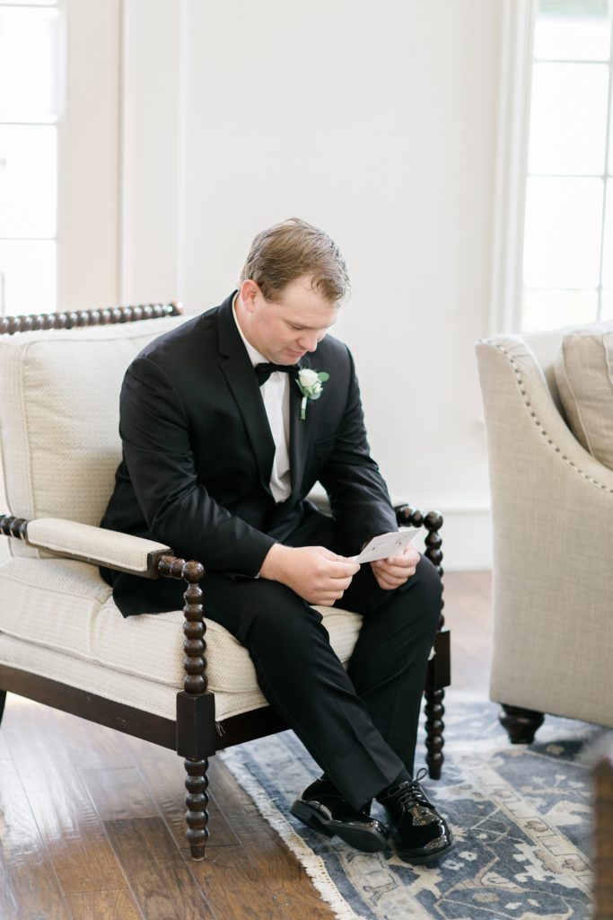 groom reads letter from bride on wedding day