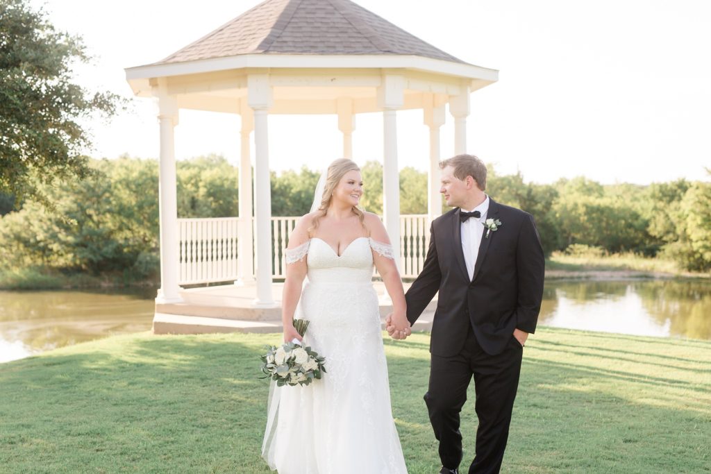 bride and groom hold hands walking away from gazebo in Texas
