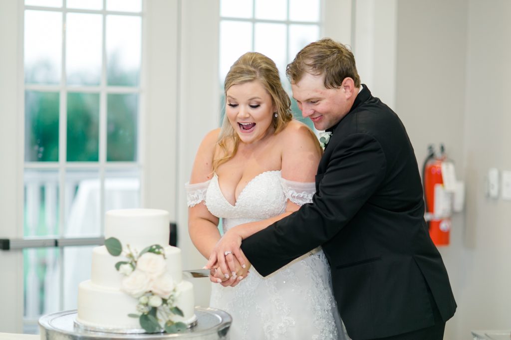 bride and groom cut wedding cake at The Milestone Denton