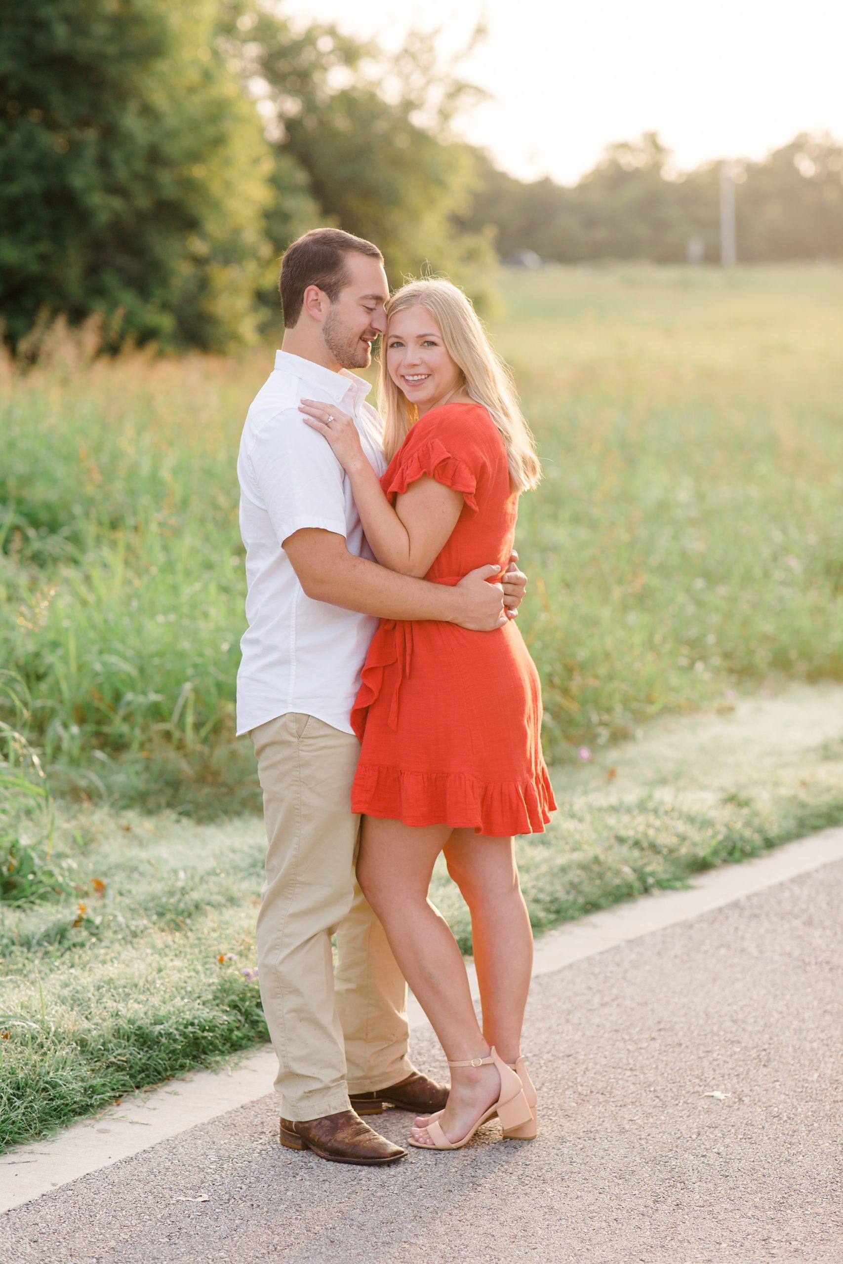 Dallas Texas engagement session with couple in orange dress and white shirt and khakis 