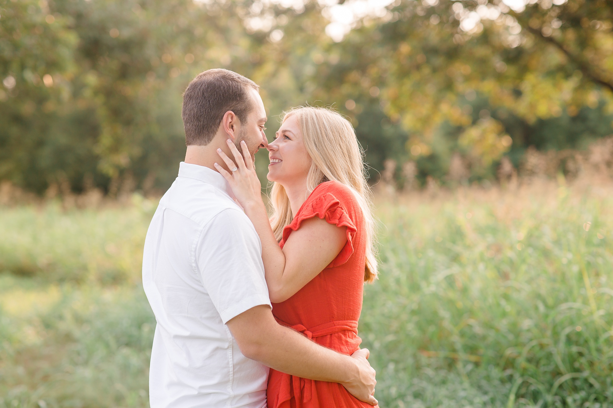 bride holds groom's face during Texas engagement session