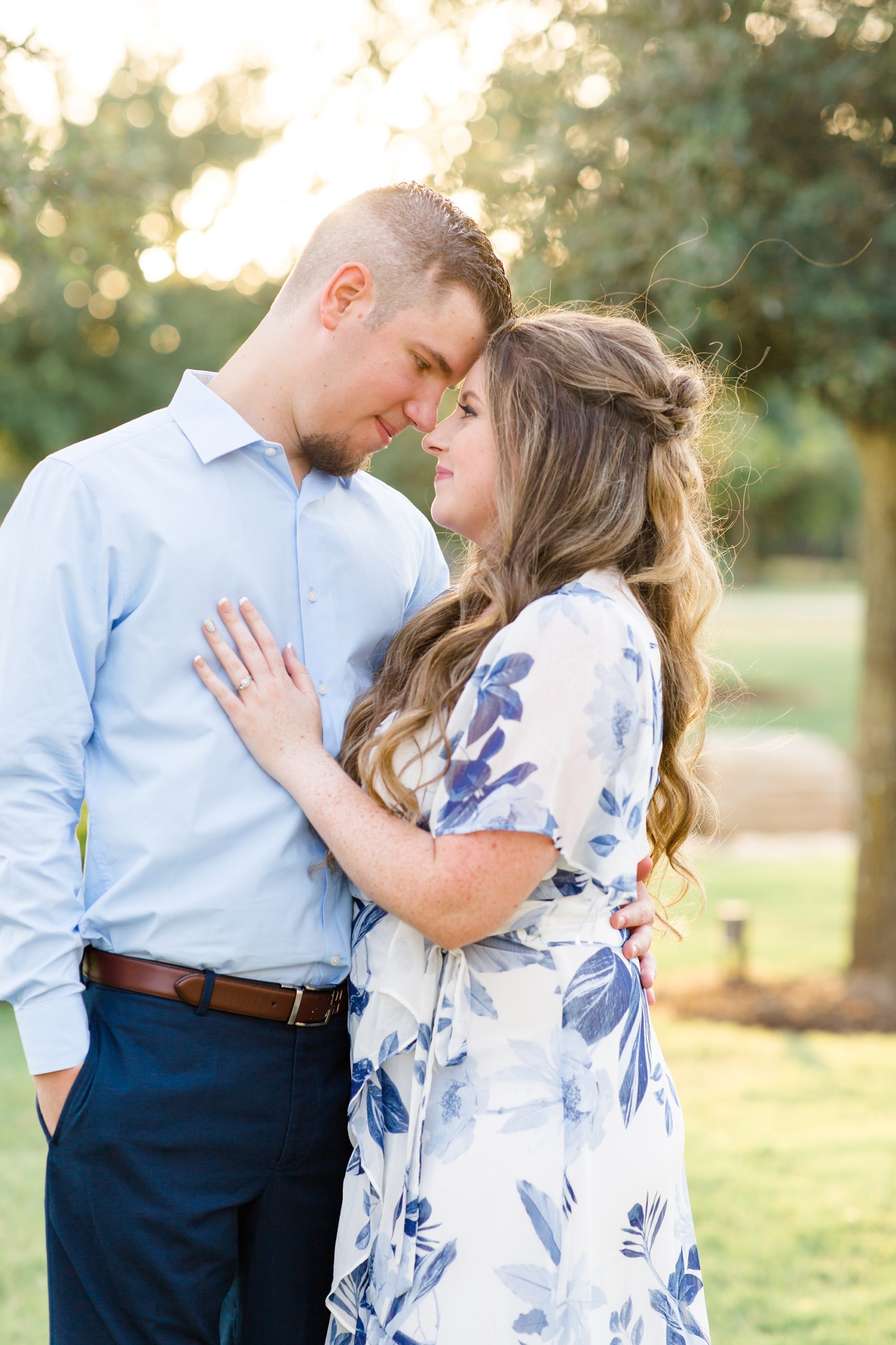 bride and groom nuzzle noses during engagement session