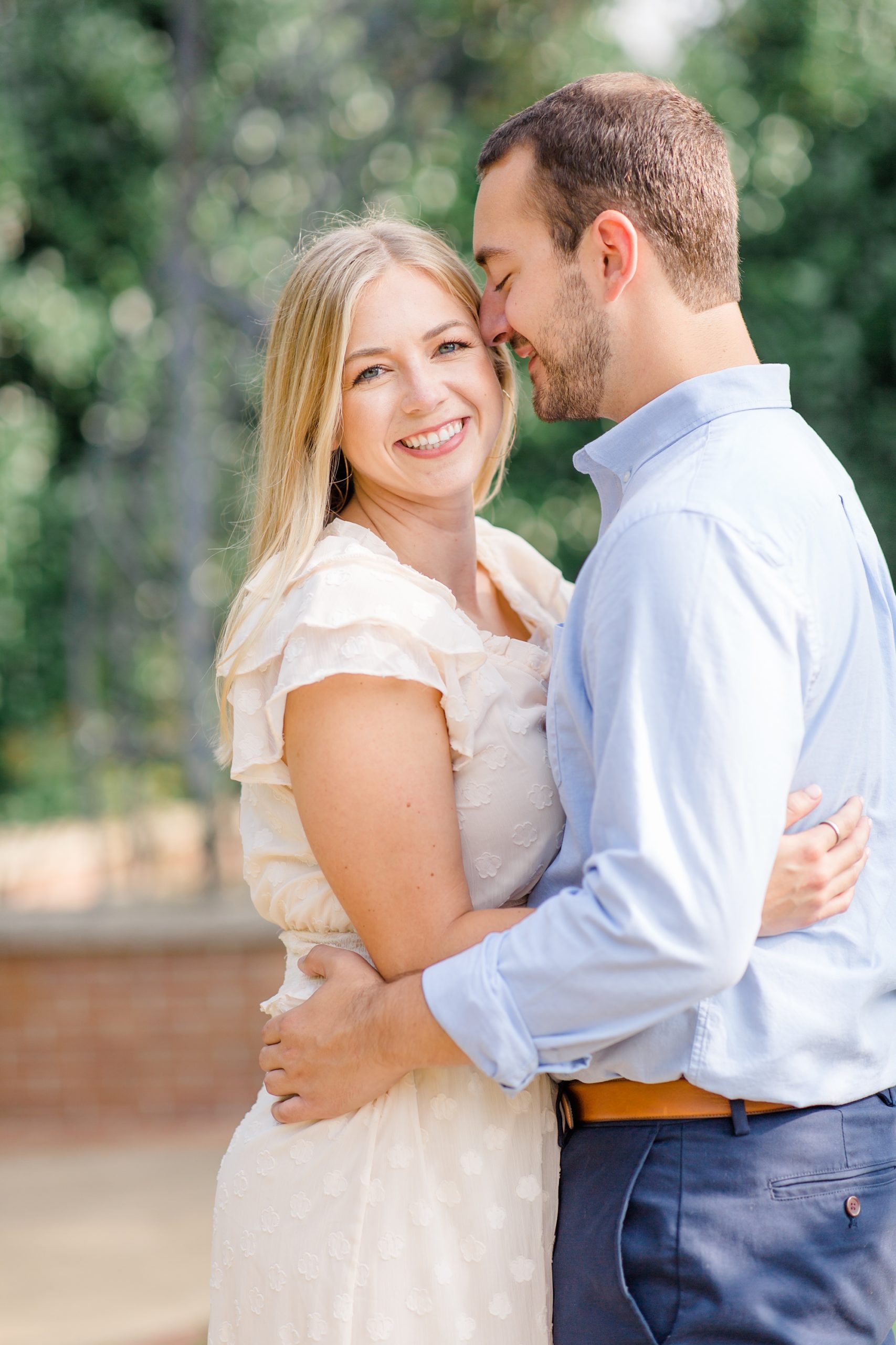 groom nuzzles bride's forehead during engagement session