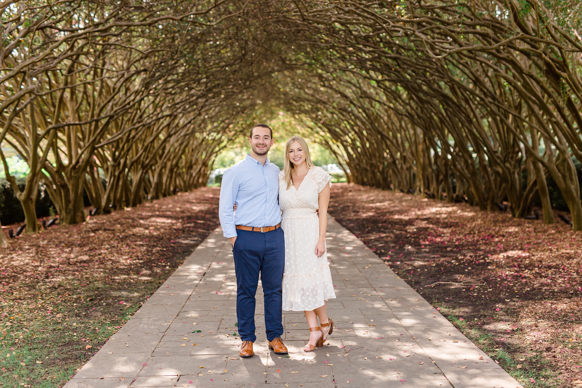 bride and groom pose in covered walkway at Dallas Arboretum
