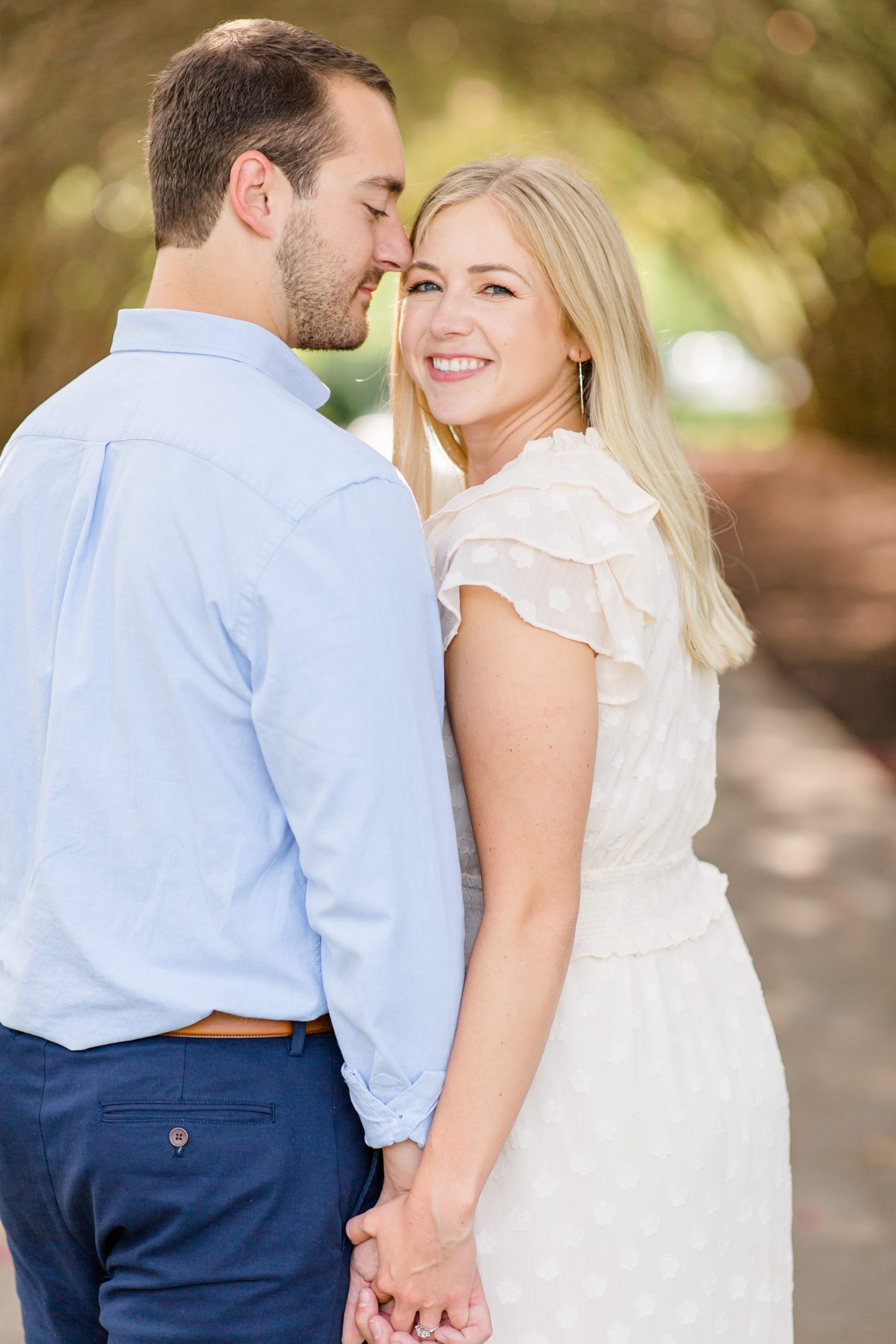 groom kisses bride on temple during engagement session