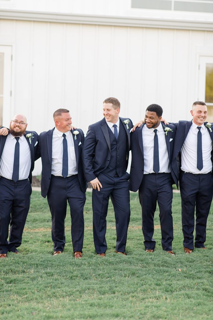 groom and groomsmen goof off before TX wedding