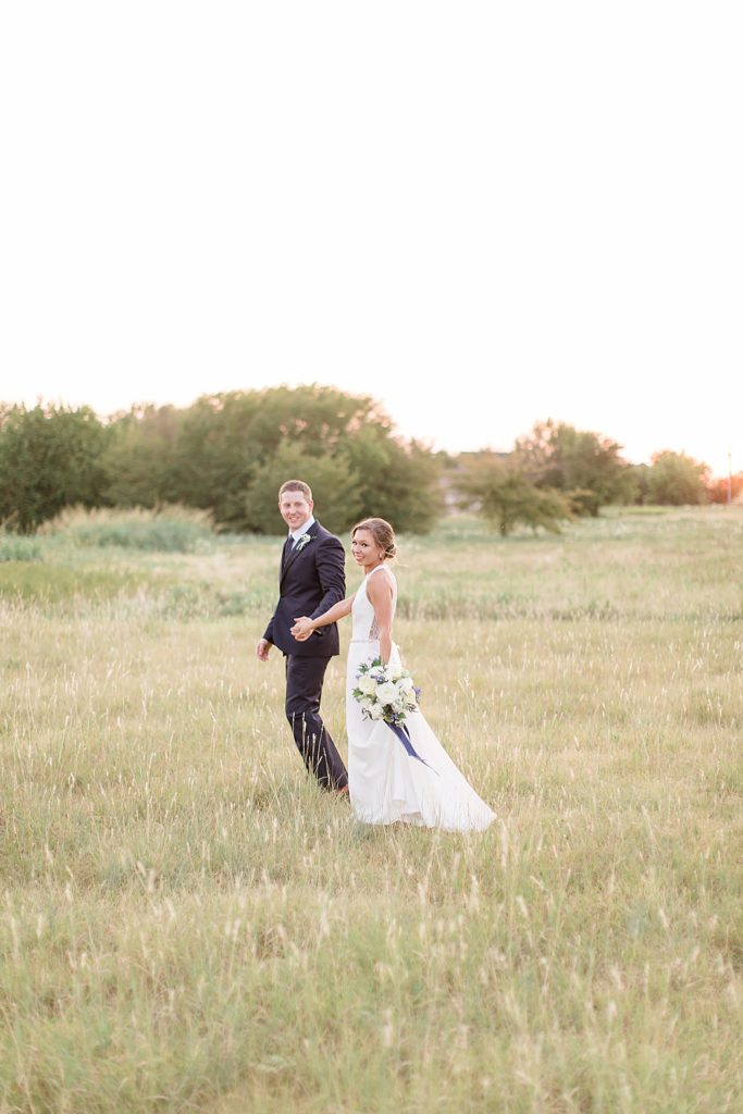 Dallas TX wedding portraits walking through field