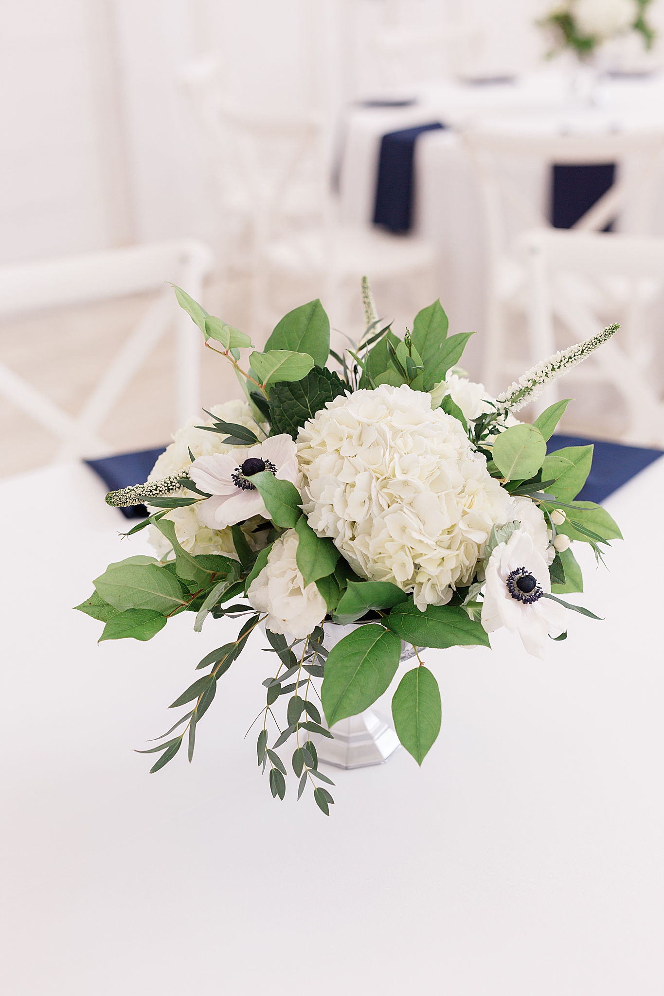 simple centerpieces with white flowers and blue accents